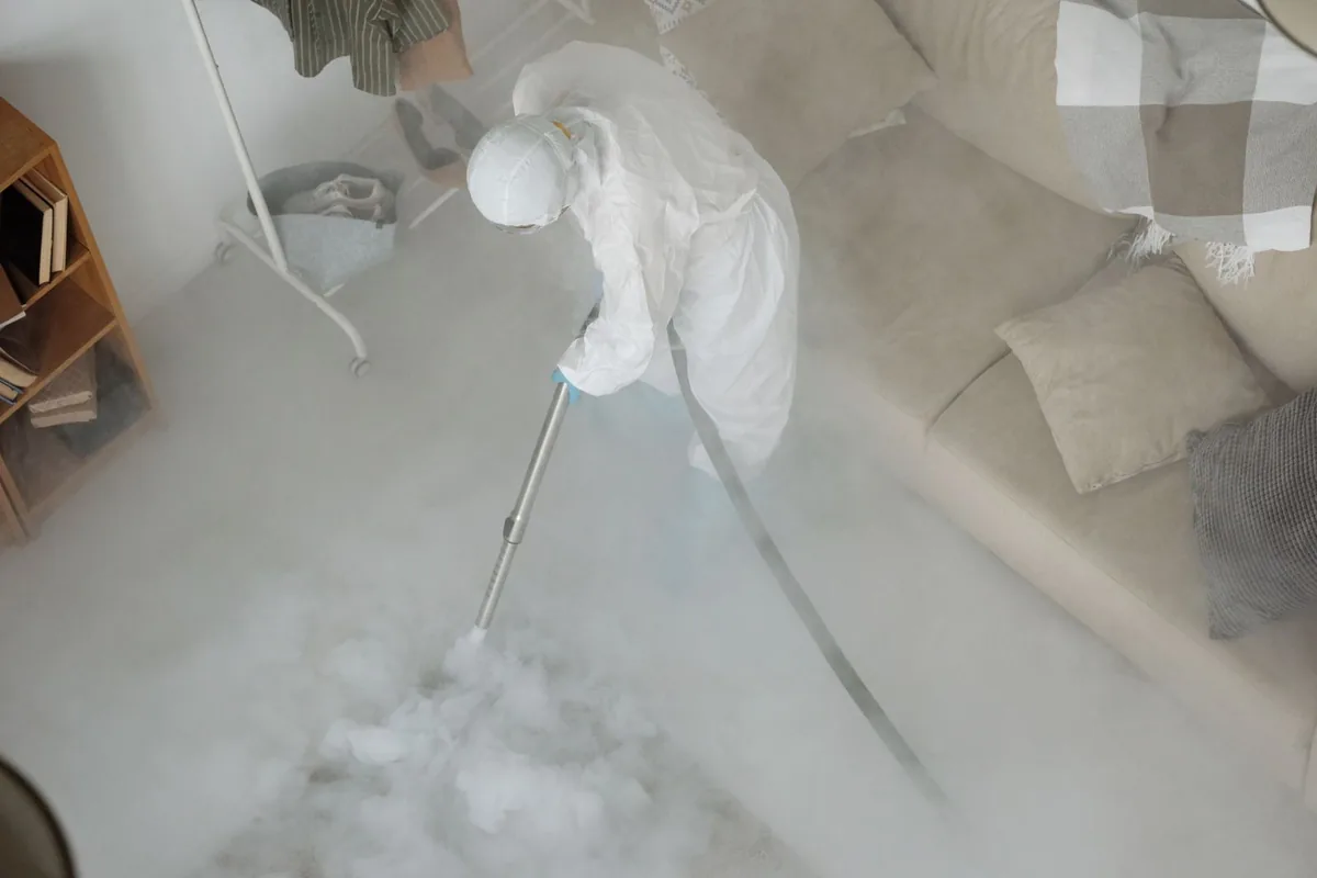 Biohazard cleanup technician in protective equipment, Asbury Park, NJ